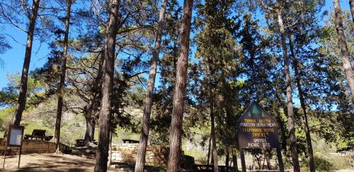 a sign in the middle of a forest with trees at The Summer Haven in Polis Chrysochous