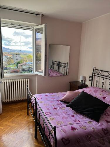 a bedroom with a bed and a large window at B&B del Lago in Sansepolcro