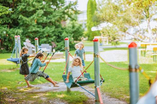a group of children playing on a playground at Rheinhotel Dreesen in Bonn