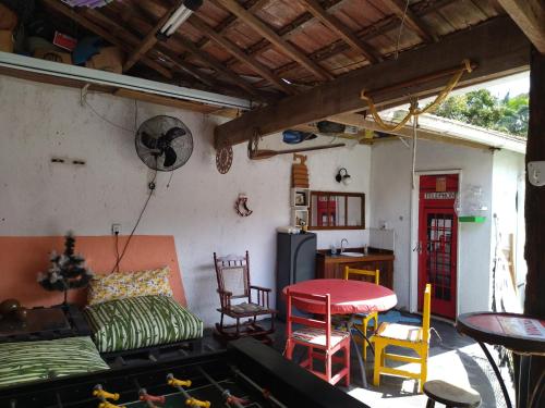 a living room with a couch and chairs and a table at Casa Pousada Cantinho Secreto in Ubatuba