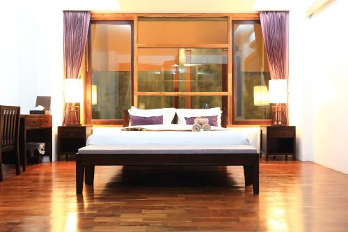 a bedroom with a large white bed in a room at Bundhaya Villas in Ko Lipe
