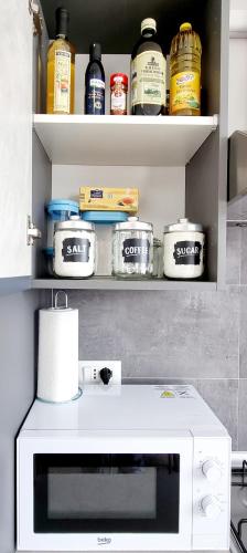 a kitchen with a shelf with food items on it at GUEST HOLIDAY BARI in Reggio Emilia