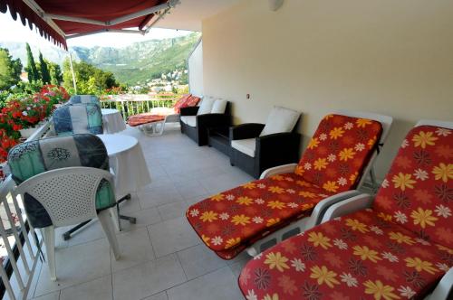 a balcony with chairs and a table with a view at Hotel Haus Am Meer Cavtat in Cavtat
