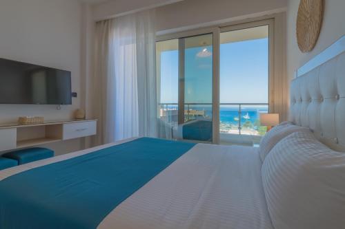 a bedroom with a large bed with a view of the ocean at Redcon Suites in Hurghada
