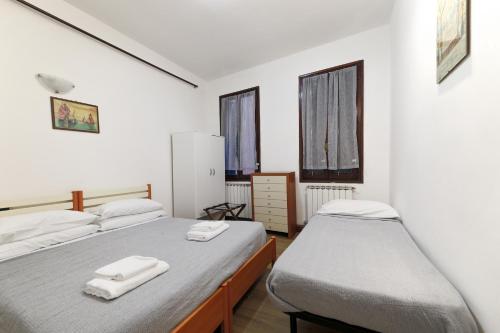 a bedroom with two beds with towels on them at Rialto House wi-fi in Venice