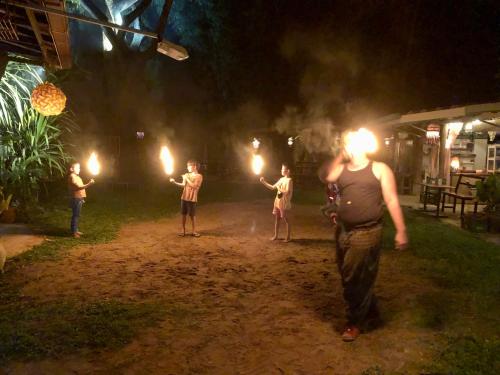 a group of people holding lights in the dark at Good Life Dacha Wellness Homestay in Pai