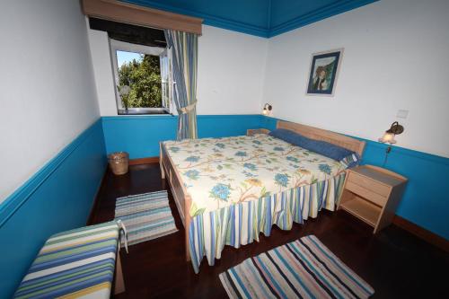 una piccola camera da letto con un letto e una finestra di Casa do Ribeirinho a Porto Moniz