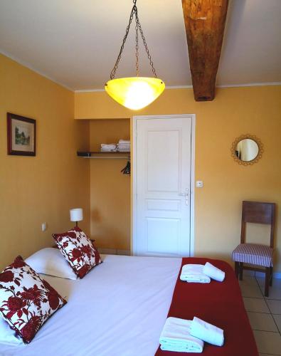 a bedroom with a large white bed with two towels at Anjou Golf and Country Club in Champigné