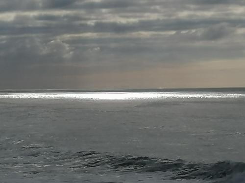 a view of the ocean with the sky and clouds at La Tour du Bois Dormant in Plozévet