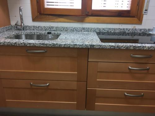 a kitchen with a sink and a granite counter top at Saldaña. Apartamento in Saldaña