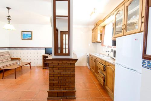 a kitchen with a brick oven in the middle at Casas da Vila - Duna Parque Group in Vila Nova de Milfontes