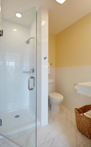 a bathroom with a glass shower and a toilet at The Hotel Maria in Westerly