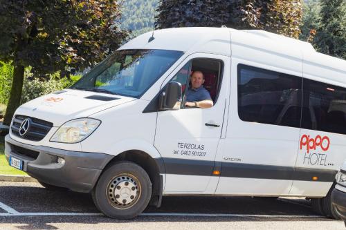 a man sitting in the drivers seat of a van at Pippo Hotel in Terzolas
