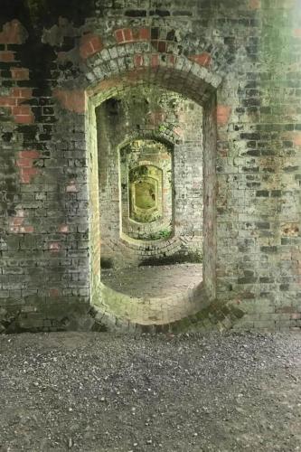 a brick wall with a window in the middle at Lapwing Lake Lodge in Cirencester