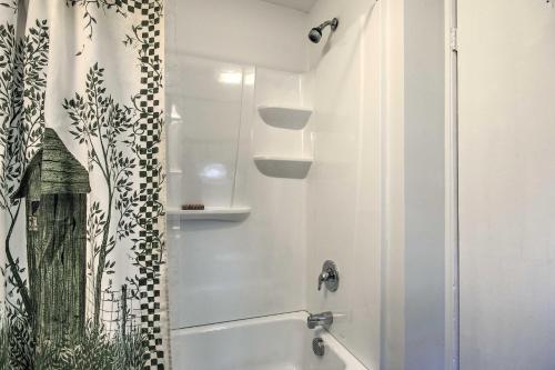 a white bathroom with a shower and a tub at 2 Mi to Lake Hartwell Charming Southern Cottage in Anderson