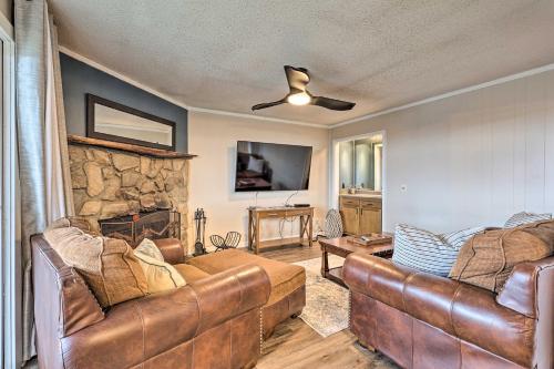 a living room with two couches and a stone wall at 2 Mi to Skiing! Resort-Style Beech Mountain Condo in Beech Mountain