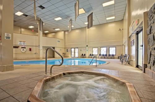 a hot tub in a large room with a swimming pool at 2 Mi to Skiing! Resort-Style Beech Mountain Condo in Beech Mountain