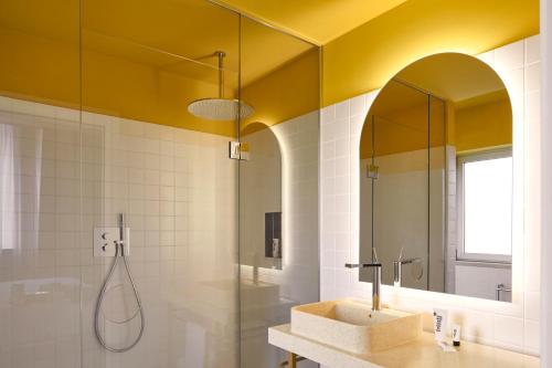a bathroom with a sink and a shower at Mama Shelter Roma in Rome