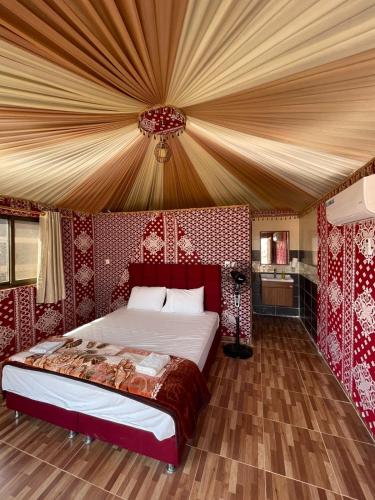 a bedroom with a large bed in a tent at Sand Star Camp in Wadi Rum