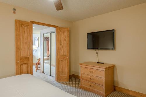 a bedroom with a bed and a flat screen tv at Grand Lodge Condo in the Heart of Mt Crested Butte condo in Crested Butte