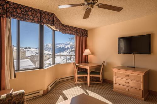 a hotel room with a desk and a large window at Grand Lodge Condo in the Heart of Mt Crested Butte condo in Crested Butte