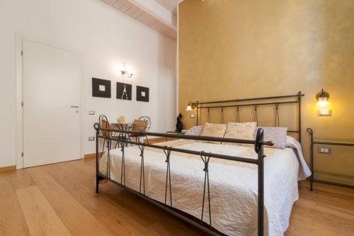 a bedroom with a bed with a metal frame at Marina Di Castello in Cagliari