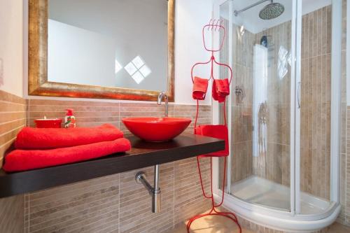a bathroom with a red sink and a shower at Marina Di Castello in Cagliari
