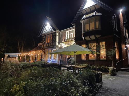 a house with an umbrella in front of it at night at The lodge at Carlton tavern free parking in York