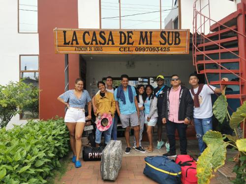a group of people standing in front of a building at La Casa De Mi Sub in Puerto Baquerizo Moreno