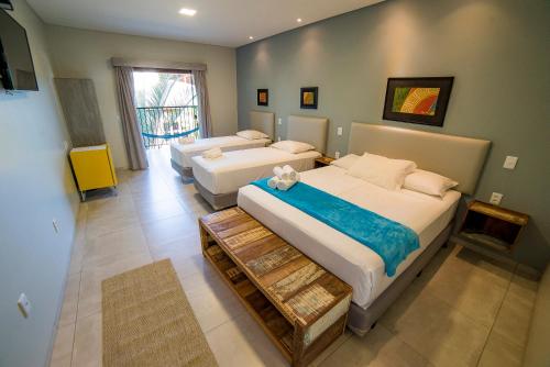 a large bedroom with two beds and a couch at Pousada Girassol in Bonito
