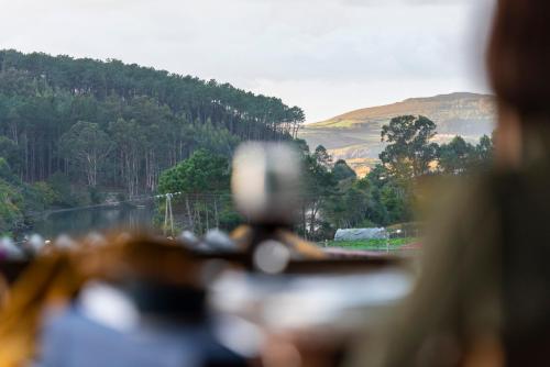 a person looking out a window at a view of a mountain at LIRESCA in Lires