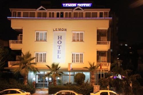فندق ليمون  في أنطاليا: مبنى اصفر مع لافته مكتوب عليها فندق لينوكس