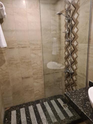 a shower with a glass door in a bathroom at Oyster Bay Marsa Alam ( Unit I5-06) in Abu Dabab
