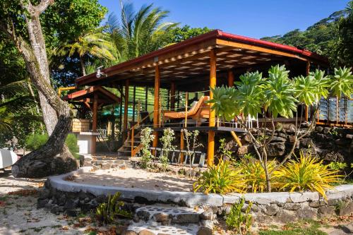 a pavilion with a playground in a garden at Raiatea sur Mer in Opoa
