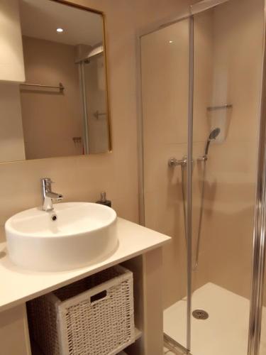 a bathroom with a sink and a shower at Nora Velha T1 in Tavira