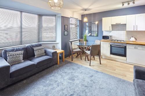 a living room with a couch and a table at Queens Road 2 Bed apartments Central Richmond in Richmond