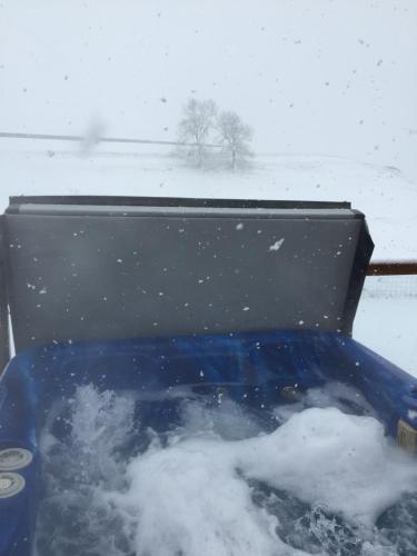 a blue jeep is covered in snow at Breeze Place in Nelson