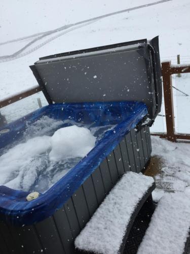 a blue trash can with snow on top of it at Breeze Place in Nelson