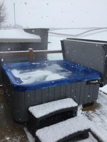 a jacuzzi tub with snow on top of it at Breeze Place in Nelson