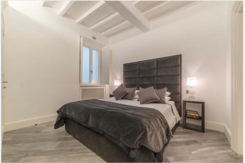 a bedroom with a large bed and a window at Reale Luxury Home in Rome