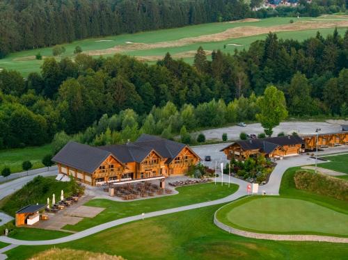an aerial view of a large house with a golf course at Hotel Cubo in Ljubljana