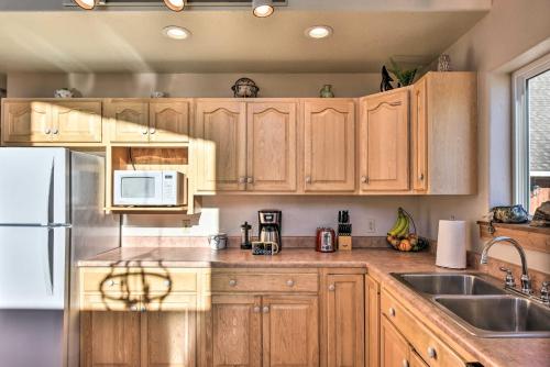 a kitchen with wooden cabinets and a white refrigerator at Near Hikes and Arkansas River Mtn-View Getaway! in Nathrop