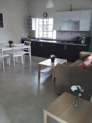 a living room with a couch and a table and a kitchen at Apartahotel MACADANA in Nagua