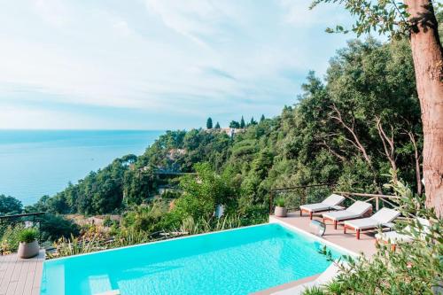 a villa with a swimming pool and a view of the ocean at L'Olearia Luxury Country Villa in Amalfi Coast in Maiori