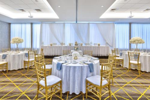 a conference room with tables and chairs and tablesktop at Holiday Inn St Johns by IHG in St. John's
