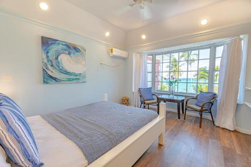 a bedroom with a bed and a desk and a window at Sunshine Studio at Viking Hill - Love Beach in Nassau