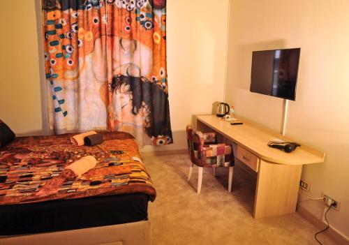 a bedroom with a desk and a bed with a curtain at SMART in Niš