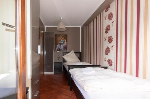 a room with two beds and a painting on the wall at Boutique Hotel Sena in Berlin