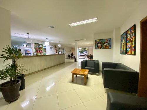 a waiting room with couches and a table in a hospital at Hotel Skalla - MELHOR CUSTO BENEFICIO in Teixeira de Freitas