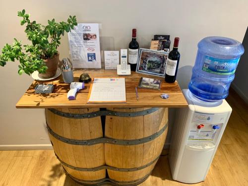 a table made out of a wine barrel with wine bottles at Hostal del Valle in Santa Cruz